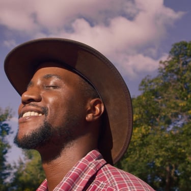 Portrait of a farmer smiling in sunlight in The Farm We Call Home film.