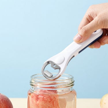Close-up of a hand placing a sleek white automatic jar opener onto a glass jar of peaches, bright high-key studio lighting, clean light blue background, focus on the product