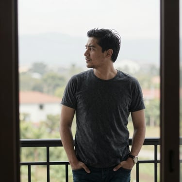 man standing near balcony