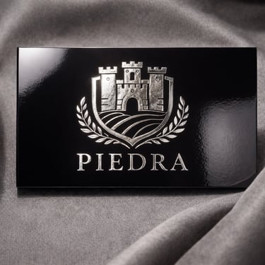 Dark business card with metallic silver embossed crest logo