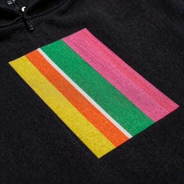Macro shot of a vibrant DTF print transfer on a black cotton hoodie, showing smooth texture and sharp edge fidelity.