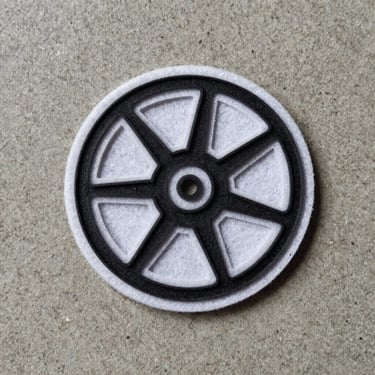 Top-down flat lay of a crisp laser-cut felt patch with clean sealed edges on a concrete background.