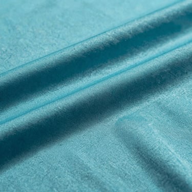 Close-up of a sublimated sports jersey fabric, showing seamless color integration directly into the polyester fibers under bright studio light.