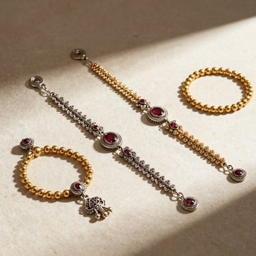 Elegant silver anklets and traditional pooja articles arranged on a clean cream stone surface, soft natural light
