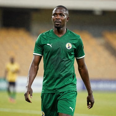 Portrait of a Ugandan football scout and partnership lead, athletic build, outdoor stadium background in soft focus.