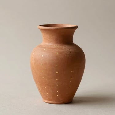 Terracotta soliflore vase with vertical lines of gold micro-dots, soft natural side-light, minimalist neutral background
