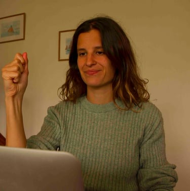 Laura Capit sitting at a table with a laptop computer