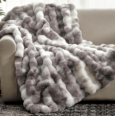  multicolored textured throw blanket (grey and white shades)