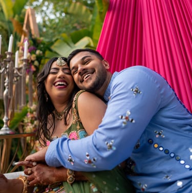 a man and woman in a colorful dress and a man in a blue suit