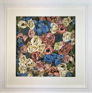 a pink and blue flower wall style preserved wedding bouquet in a frame