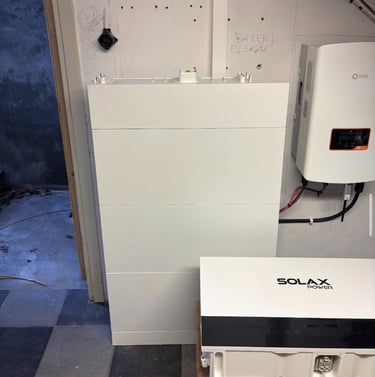 SolaX Power battery storage system and hybrid inverter installed in a residential utility room.