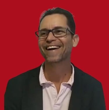 André Randon sorrindo. Fundo vermelho.