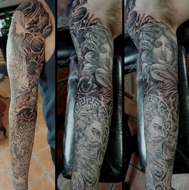 Black and grey Greek themed sleeve tattoo