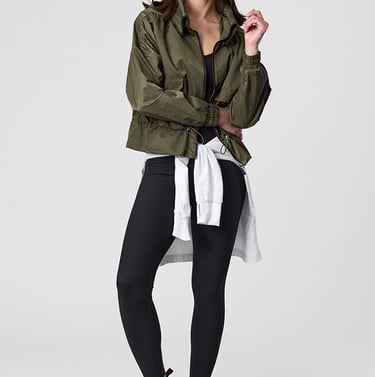 Fashion e-commerce photography - a woman in a green jacket and black leggings