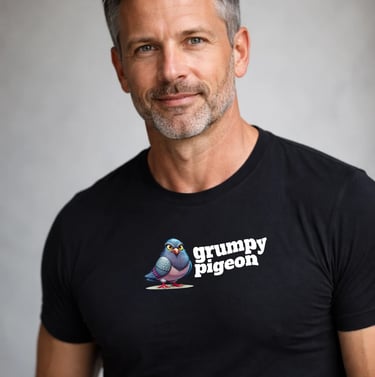 Handsome man wearing a black Grumpy Pigeon trendy t-shirt with a cartoon bird logo.