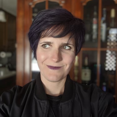 A picture of Kay, a White person wearing a black sport coat and shirt