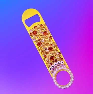 yellow flat bar key covered in. rhinestones and pearls