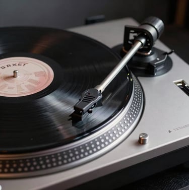 Detail shot of a high-end turntable with a vinyl record spinning. Polished silver and black metal finishes, deep gray tones. Professional and artistic North American / US music lounge setting.