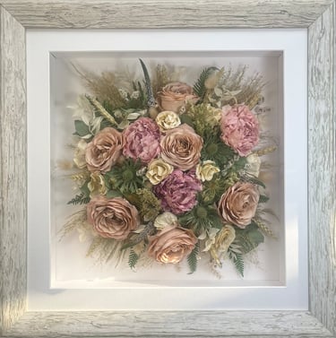 a Birdseye view preserved wedding bouquet in a frame