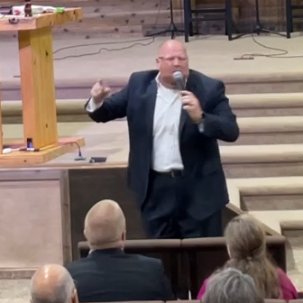 MAN SPEAKING WITH MICROPHONE