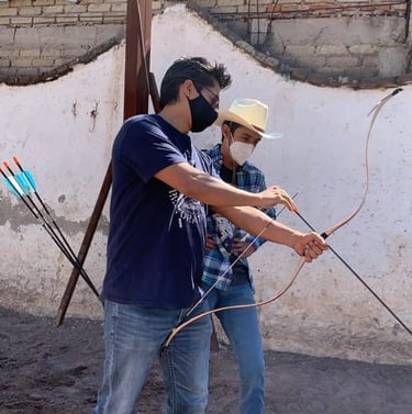 horsearchery instructor teaching archery to a young student