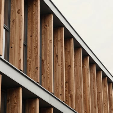 Detail of a wooden brise-soleil on a modern building, soft off-white background, precise technical lines, editorial style, high contrast between wood and light silver gray structure.
