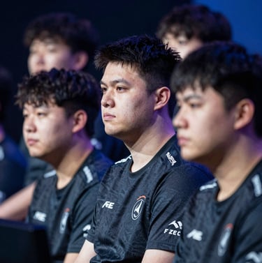 A high-resolution shot of pro-players on stage, focused on their intense expressions, under dramatic studio lighting with hints of #1F2E3A and #4A6075.