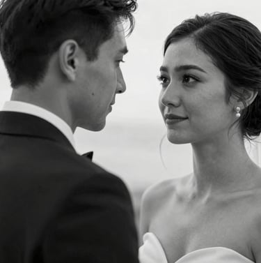 A black and white style photograph using dark charcoal and off-white tones of a North American / European couple during their wedding ceremony. The composition is intimate and close-up, focusing on their expressions. Soft lighting highlights the refined textures of their attire.
