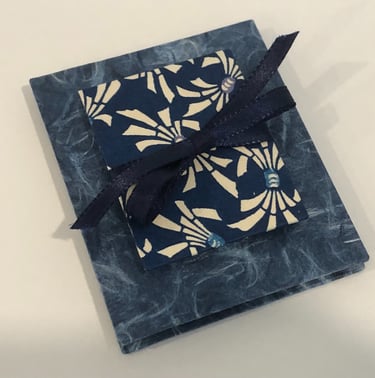 Accordion with Japanese paper and small accordion on cover, ribbon detail