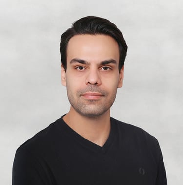 Portrait of a VISUALISE team member in a black shirt, neutral background, soft lighting, and centered composition.