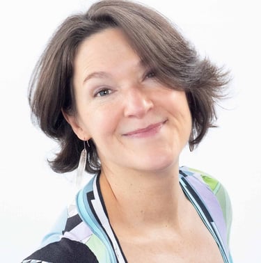 a woman with a haircut and a white shirt