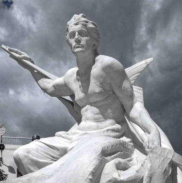 Majestic white marble sculpture of a fisherman figure against a dramatic cloudy sky.