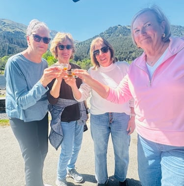 a group of people standing around outside with drinks