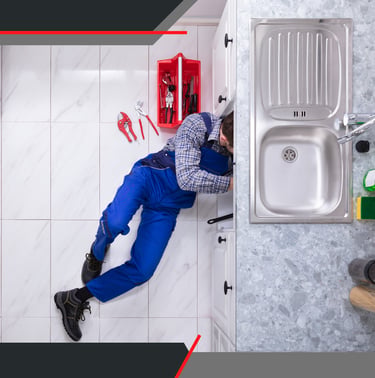 a plumber in a kitchen with a sink and a sink