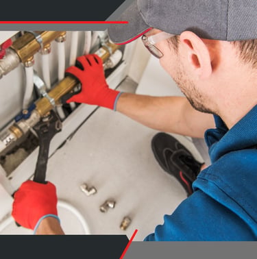 a plumber in a blue shirt and red gloves