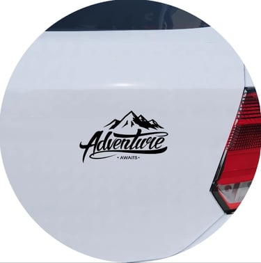 Adventure Awaits mountain vinyl decal sticker on the trunk of a white car.