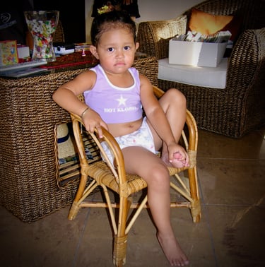 Jessica Pickering, aged 3, sitting in a wicker ch