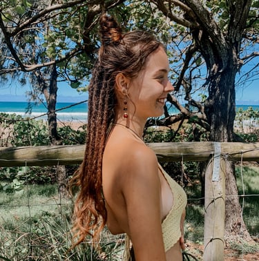 a woman at the beach with dreadlocks