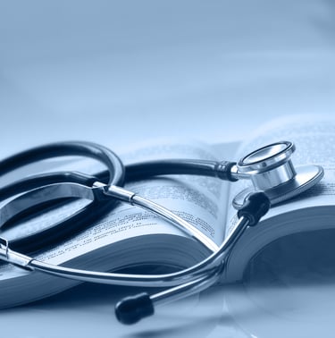 An open medical book with a stethoscope on top of it