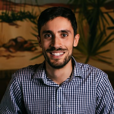 John William, a math and economics tutor, smiling in a professional headshot.