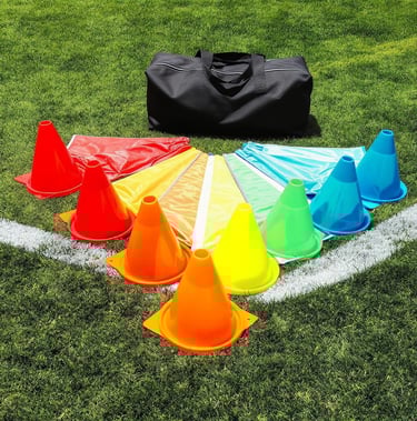 a soccer field with a bag ,training bibs and cones