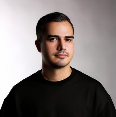 Portrait of a VISUALISE team member in a black shirt, neutral background, soft lighting, and centered composition.