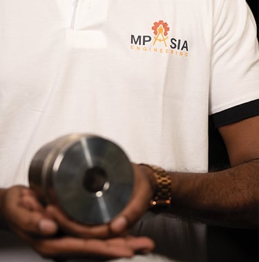 MP Asia Engineering Staff holding a CNC Precision Tool