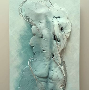 A relief sculpture of a fragmented female (rear view) entwined with wires, painted grey-blues