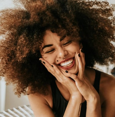 a woman with a curly afro hairs and a black dress
