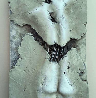 A relief sculpture of a fragmented female (rear view) showing exposed wires, painted cool browns
