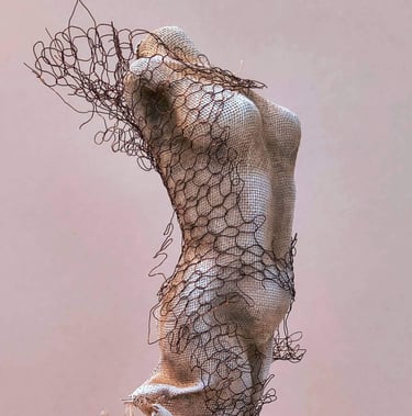 Close up of a female torso, clothed in tight fitting fabric, wrapped in torn copper wire netting