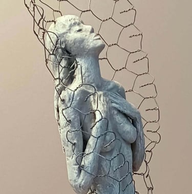 Close up of a female figure, leaning back with eyes closed, surrounded by a wire netting enclosure