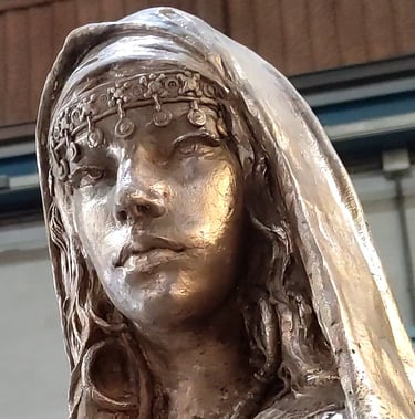 Bronze sculpture of a Muslim princess with traditional headdress and veil.