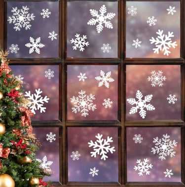 window with christmas tree on the very left with snowflake window stickers on 
